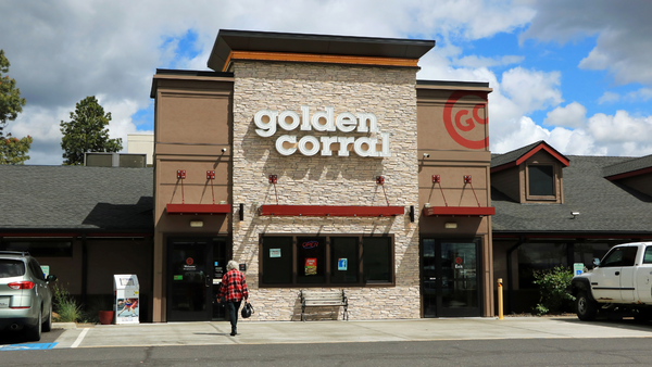 An image of the front of a building shows a person walking in. The building says "golden corral" on it.